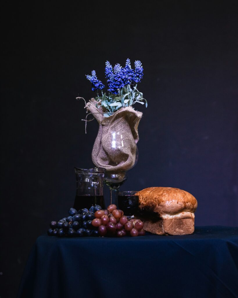 blue flower in vase, red and dark coulour